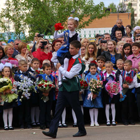 Moscow, Russia - September 1, 2015: School line is in schoolyard with pupils and teachers. Children go back to school. The Knowledge Day in Russia, first day of school.のeditorial素材