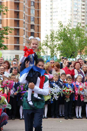 Moscow, Russia - September 1, 2015: School line is in schoolyard with pupils and teachers. Children go back to school. The Knowledge Day in Russia, first day of school.のeditorial素材
