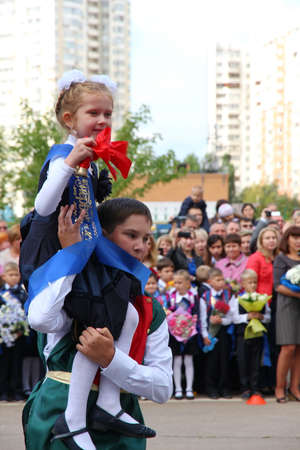 Moscow, Russia - September 1, 2015: School line is in schoolyard with pupils and teachers. Children go back to school. The Knowledge Day in Russia, first day of school.のeditorial素材
