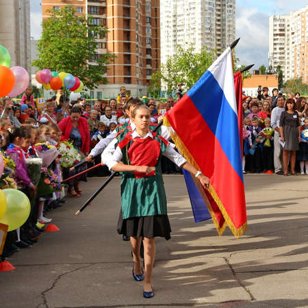 Moscow, Russia - September 1, 2015: School line is in schoolyard with pupils and teachers. Children go back to school. The Knowledge Day in Russia, first day of school.のeditorial素材