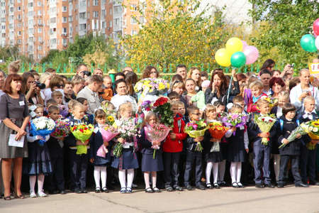 Moscow, Russia - September 1, 2015: School line is in schoolyard with pupils and teachers. Children go back to school. The Knowledge Day in Russia, first day of school.のeditorial素材