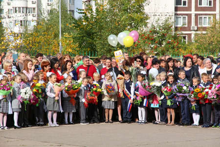 Moscow, Russia - September 1, 2015: School line is in schoolyard with pupils and teachers. Children go back to school. The Knowledge Day in Russia, first day of school.のeditorial素材
