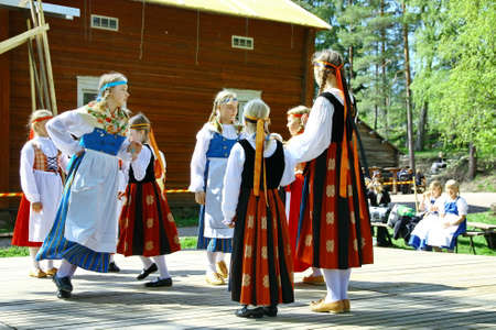 HELSINKI, FINLAND - JUNE 20, 2012: Unidentified dancers in folklore ensemble in traditional folk costumes at midsummer day festival. For editorial use only.のeditorial素材