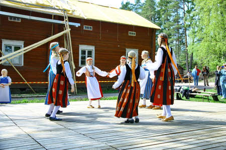 HELSINKI, FINLAND - JUNE 20, 2012: Unidentified dancers in folklore ensemble in traditional folk costumes at midsummer day festival. For editorial use only.のeditorial素材