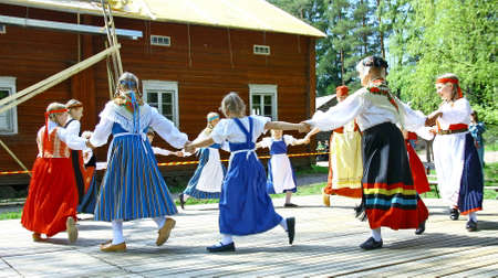 HELSINKI, FINLAND - JUNE 20, 2012: Unidentified dancers in folklore ensemble in traditional folk costumes at midsummer day festival. For editorial use only.のeditorial素材