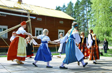 HELSINKI, FINLAND - JUNE 20, 2012: Unidentified dancers in folklore ensemble in traditional folk costumes at midsummer day festival. For editorial use only.のeditorial素材