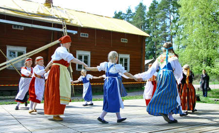 HELSINKI, FINLAND - JUNE 20, 2012: Unidentified dancers in folklore ensemble in traditional folk costumes at midsummer day festival. For editorial use only.のeditorial素材