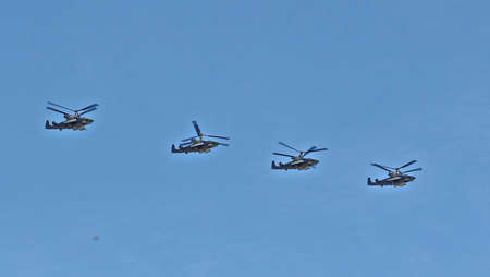 MOSCOW, RUSSIAN - MAY 9, 2013: Demonstration flight of military helicopters, a parade dedicated to the Soviet victory over Germany. For editorial use only.のeditorial素材