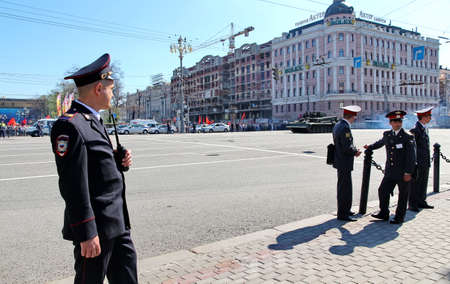 MOSCOW, RUSSIAN - MAY 9, 2013: Policemen in cordon wait for motorcade on TverskayaStreet on parade devoted to devoted to Victory Day. For editorial use only.のeditorial素材
