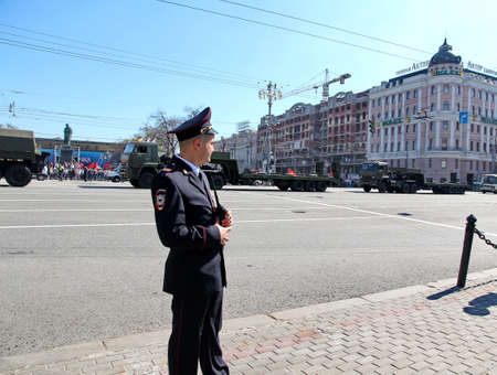 MOSCOW, RUSSIAN - MAY 9, 2013: Policemen in cordon wait for motorcade on TverskayaStreet on parade devoted to devoted to Victory Day. For editorial use only.のeditorial素材