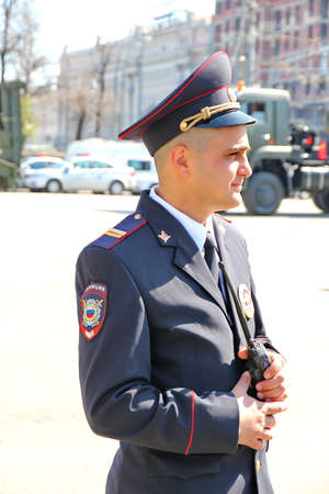 MOSCOW, RUSSIAN - MAY 9, 2013: Policemen in cordon wait for motorcade on TverskayaStreet on parade devoted to devoted to Victory Day. For editorial use only.のeditorial素材