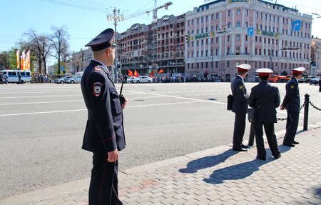 MOSCOW, RUSSIAN - MAY 9, 2013: Policemen in cordon wait for motorcade on TverskayaStreet on parade devoted to devoted to Victory Day. For editorial use only.のeditorial素材
