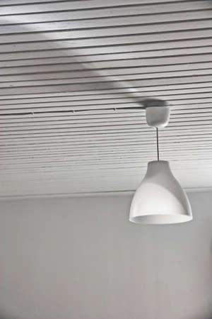 Abstract white interior with a lamp and a wood ceilingの写真素材