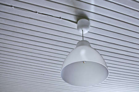 Abstract white interior with a lamp and a wood ceilingの写真素材