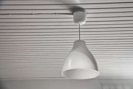 Abstract white interior with a lamp and a wood ceilingの写真素材
