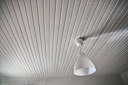Abstract white interior with a lamp and a wood ceilingの写真素材