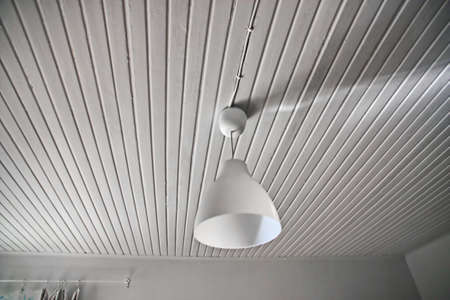 Abstract white interior with a lamp and a wood ceilingの写真素材