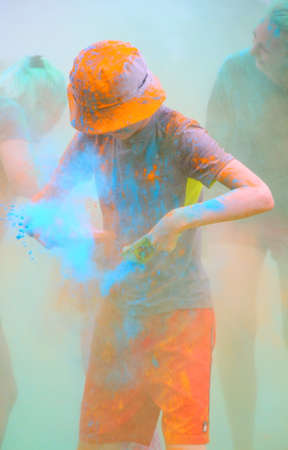 Moscow, Russia - July 14, 2018: Throwing color at the Holi color festival. Happy people during...