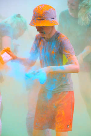 Moscow, Russia - July 14, 2018: Throwing color at the Holi color festival. Happy people during Festival of colours Holi. Holi is traditional holiday of India.のeditorial素材