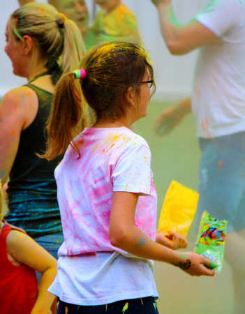 Moscow, Russia - July 14, 2018: Throwing color at the Holi color festival. Happy people during...