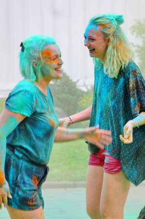 Moscow, Russia - July 14, 2018: Throwing color at the Holi color festival. Happy people during Festival of colours Holi. Holi is traditional holiday of India.のeditorial素材