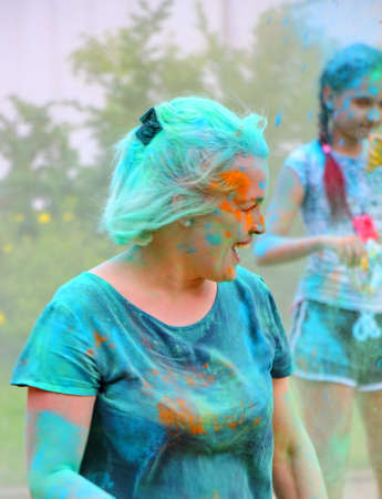 Moscow, Russia - July 14, 2018: Throwing color at the Holi color festival. Happy people during Festival of colours Holi. Holi is traditional holiday of India.のeditorial素材