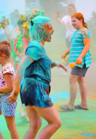 Moscow, Russia - July 14, 2018: Throwing color at the Holi color festival. Happy people during Festival of colours Holi. Holi is traditional holiday of India.のeditorial素材