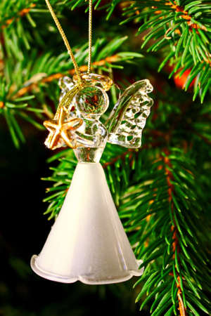 Toy glass angel decoration on the xmas treeの写真素材