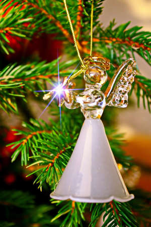 Toy glass angel decoration on the Christmas treeの写真素材
