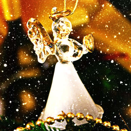 Toy glass angel decoration on the Christmas treeの写真素材