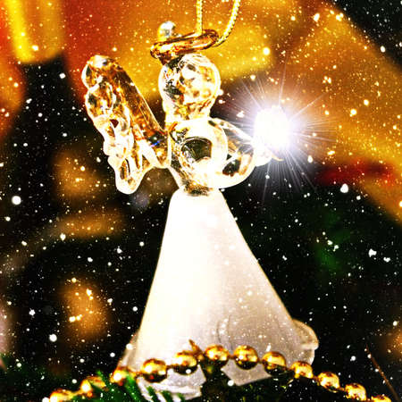 Toy glass angel decoration on the Christmas treeの写真素材