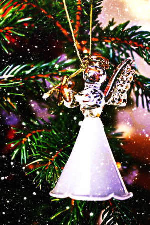Toy glass angel decoration on the xmas treeの写真素材