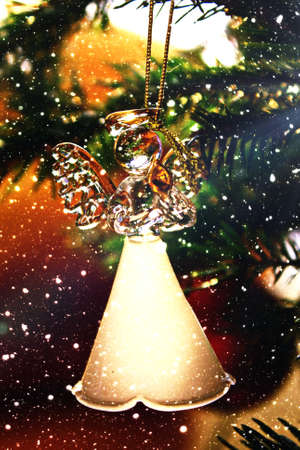 Toy glass angel decoration on the xmas treeの写真素材
