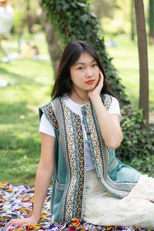 Young girl in ethnic traditional national Kazakh costume in spring gardenの写真素材