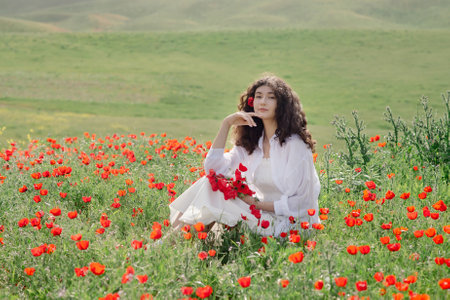 Model, beautiful woman relaxing on poppy field. Lifestyle.の写真素材
