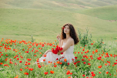 Model, beautiful woman relaxing on poppy field. Lifestyle.の写真素材
