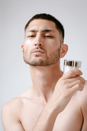 Man applying using cream. Health care concept. SPAの写真素材