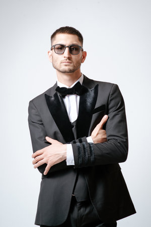 Handsome Man, Fashion model in black suit, tuxedo, bow tie and sunglassesの写真素材
