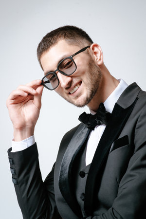 Handsome Man, Fashion model in black suit, tuxedo, bow tie and sunglassesの写真素材
