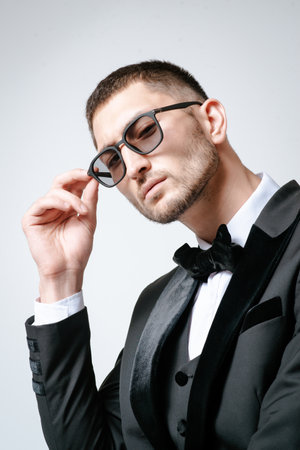 Handsome Man, Fashion model in black suit, tuxedo, bow tie and sunglassesの写真素材