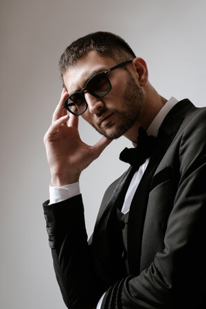 Handsome Man, Fashion model in black suit, tuxedo, bow tie and sunglassesの写真素材
