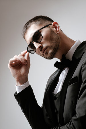 Handsome Man, Fashion model in black suit, tuxedo, bow tie and sunglassesの写真素材