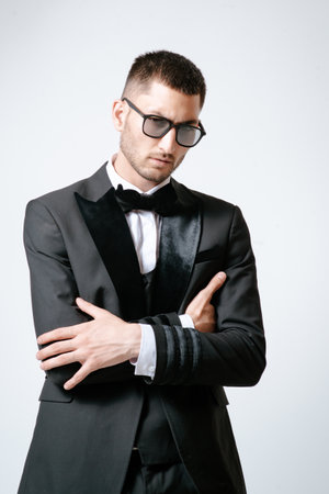 Handsome Man, Fashion model in black suit, tuxedo, bow tie and sunglassesの写真素材