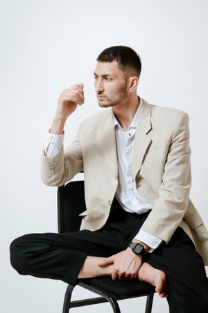 Handsome Man in costume, sits on chair. Barefootの写真素材