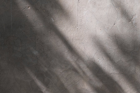 Wall with texture and shadows. Gray concrete background