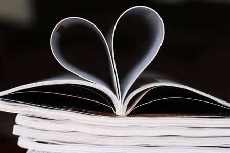 A magazine with pages folded in the shape of a heart.の写真素材