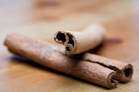 Two cinnamon sticks on a wooden tableの写真素材