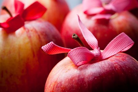 Close-up of red Christmas apples with ribbonsの写真素材