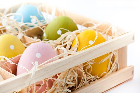 Pastel colored Easter eggs on a white background. Small DOF.