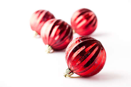 Red Christmas baubles on a white background